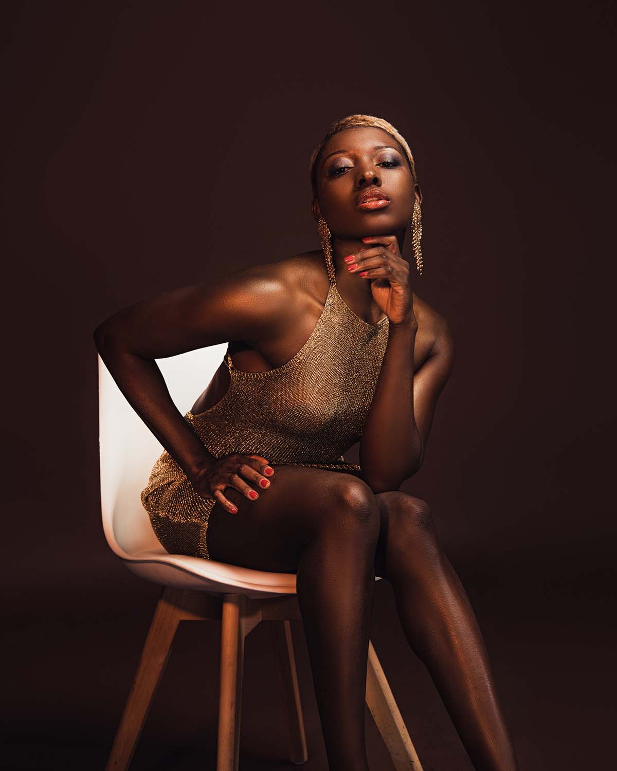 fashionable-african-american-woman-sitting-on-chai-MFTH66R.jpg